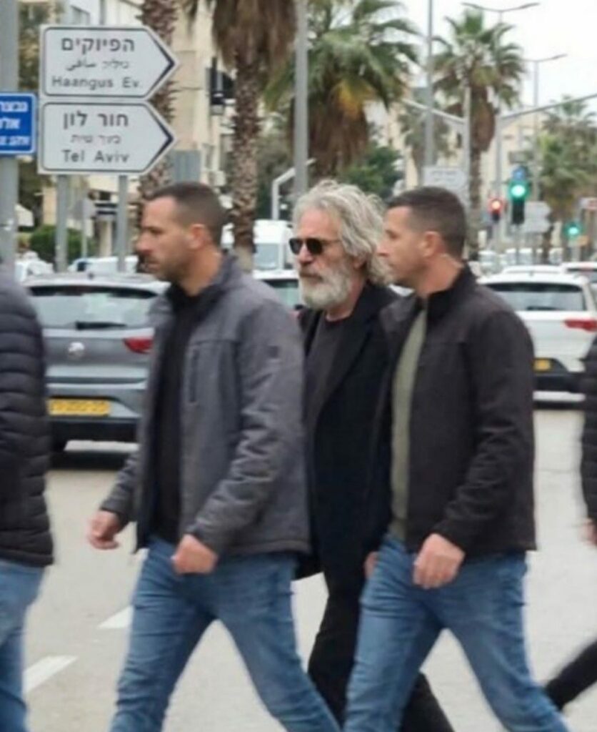 A digitally manipulated, high-resolution AI fake image showing three men walking across a busy street in Tel Aviv, Israel